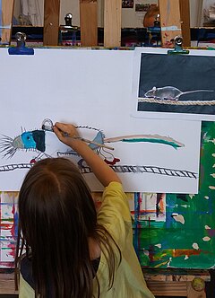Kind malend an einer Staffelei