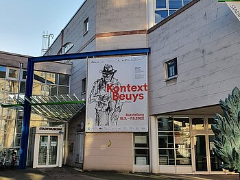 Eingang Stadtmuseum mit dem Banner zur Sonderausstellung "Kontext Beuys"